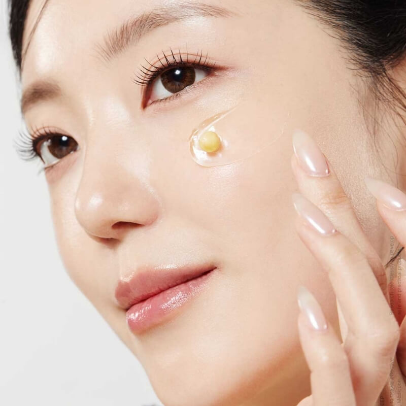 Woman applying Medicube Deep Vita C Capsule Cream to face