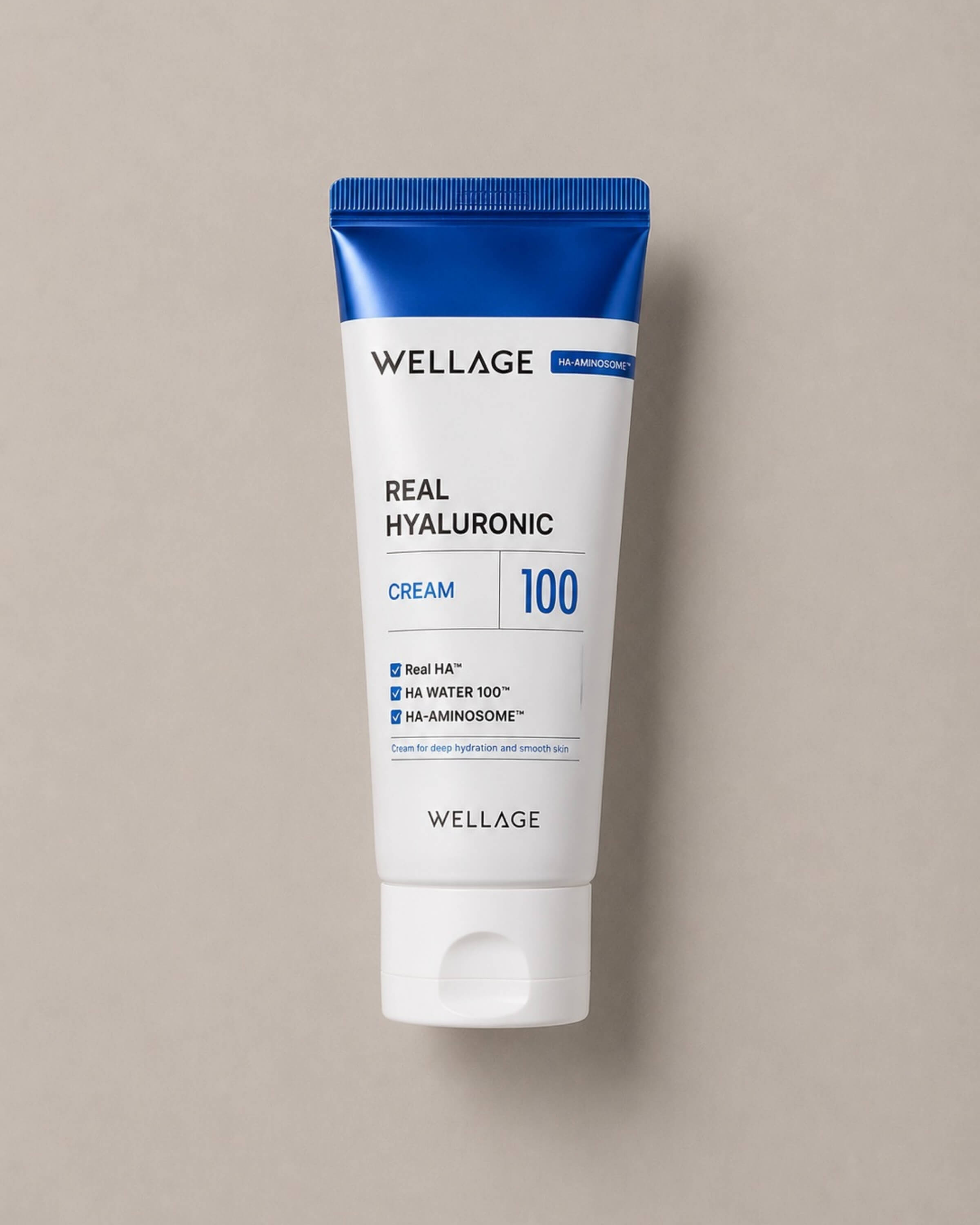 Wellage Real Hyaluronic Cream tube on a beige background