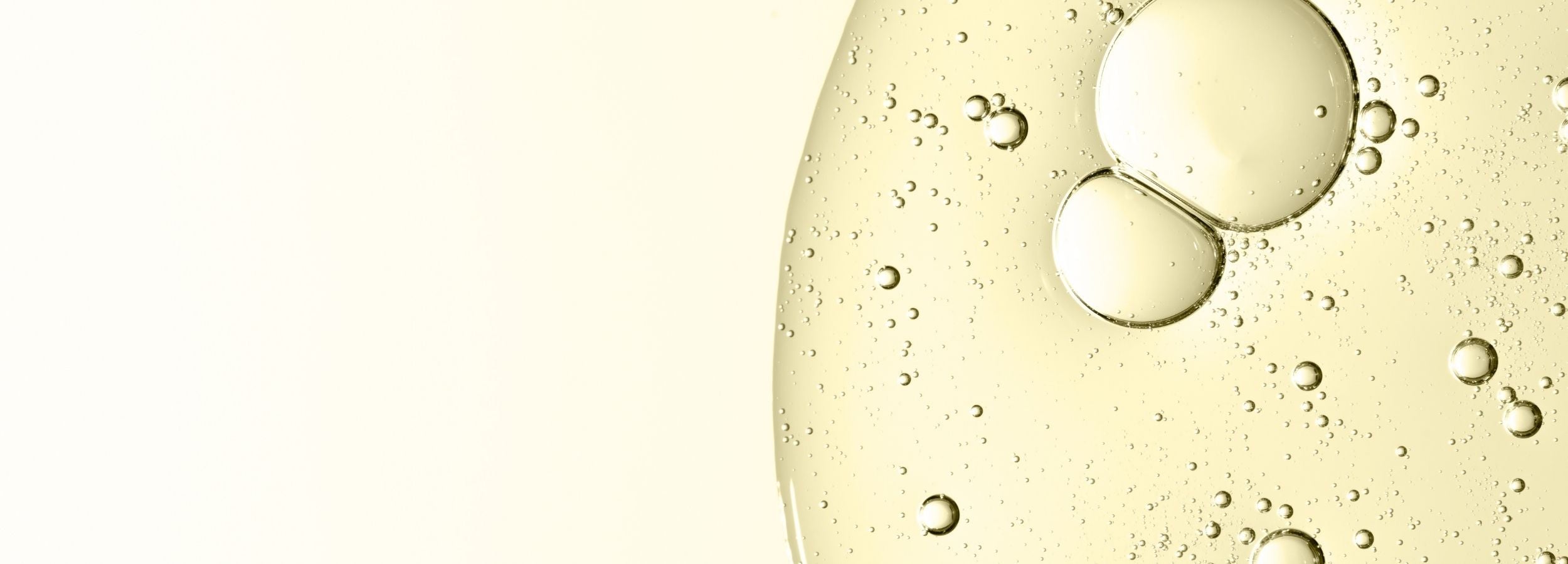 Close-up of oil droplets on a clear liquid surface