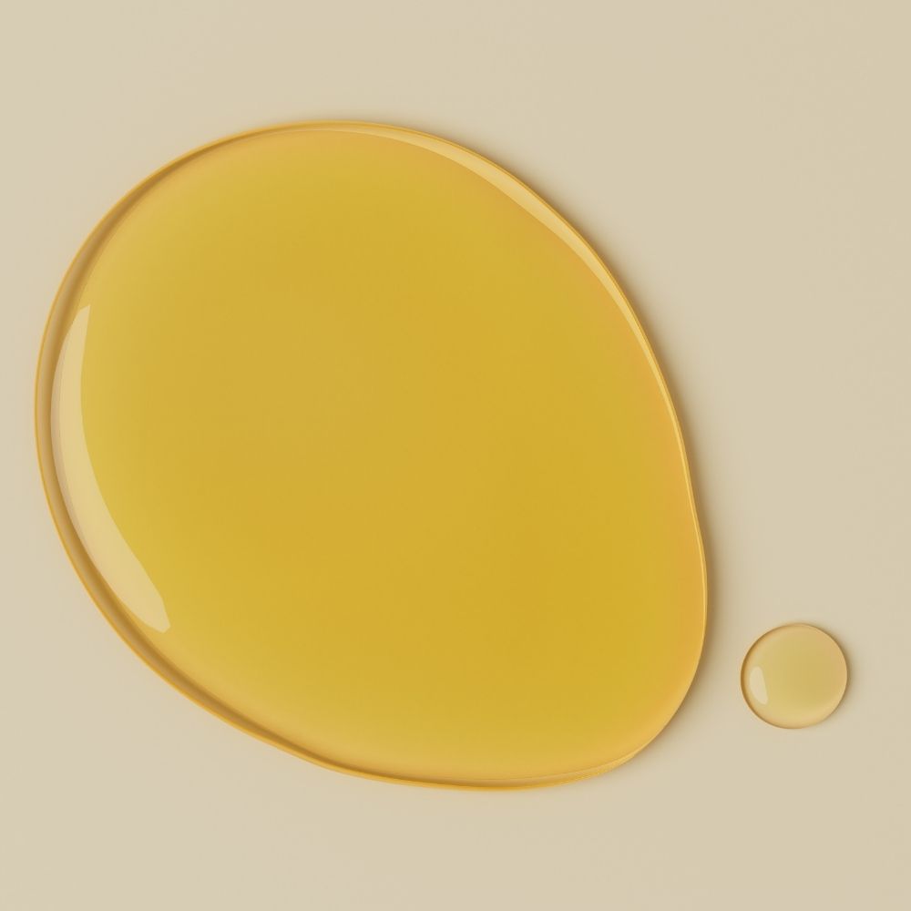 Yellow vitamin c droplet on a beige background